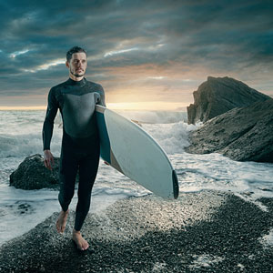 surfer wearing a wetsuit at sunset